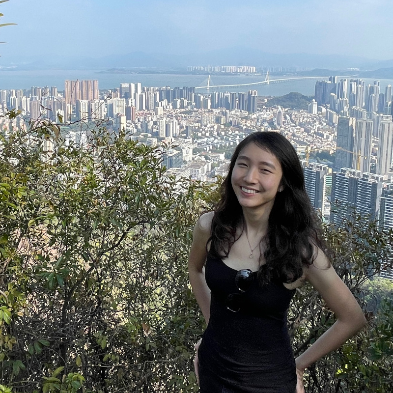 photograph of Selena She on a hilltop above a city