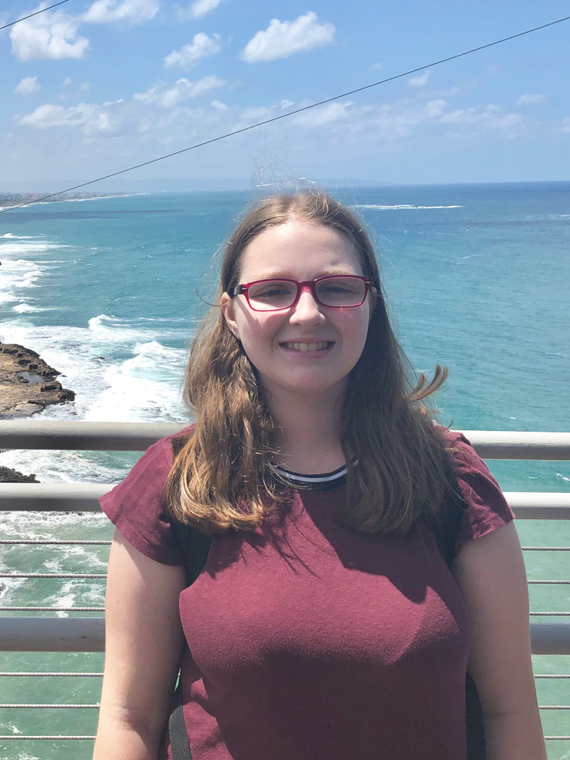 photograph of Elizabeth Rosenthal standing at a scenic overlook over the ocean