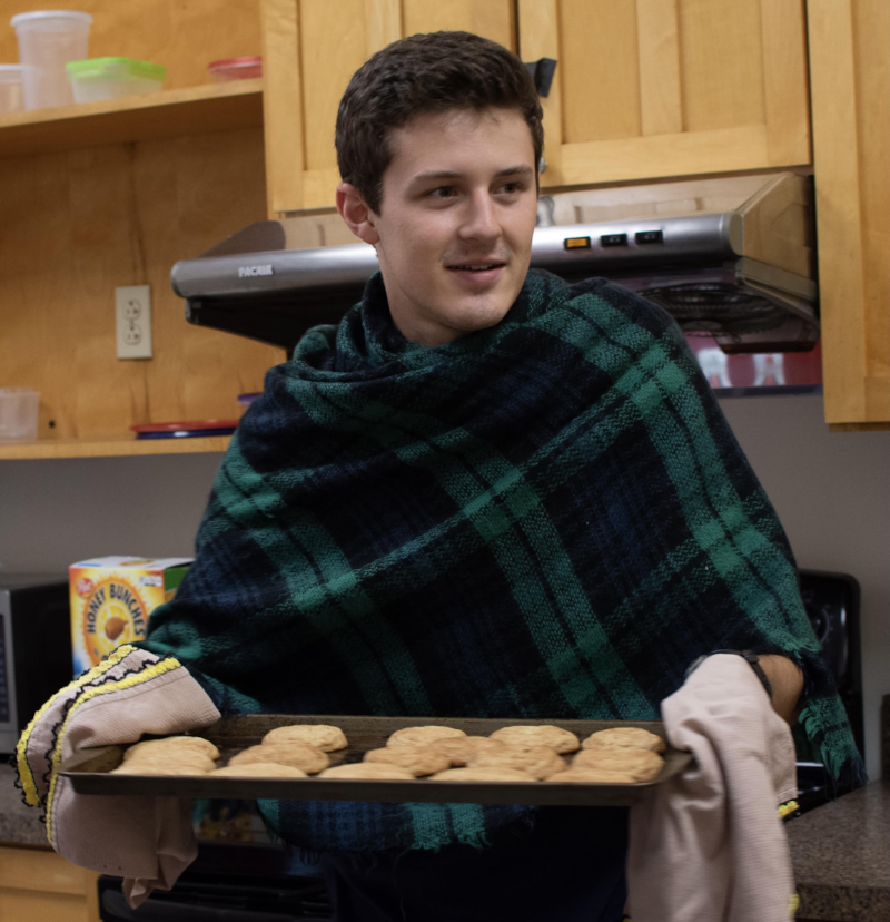 photograph of Fen Duarte holding a tray of cookies, fresh from the oven