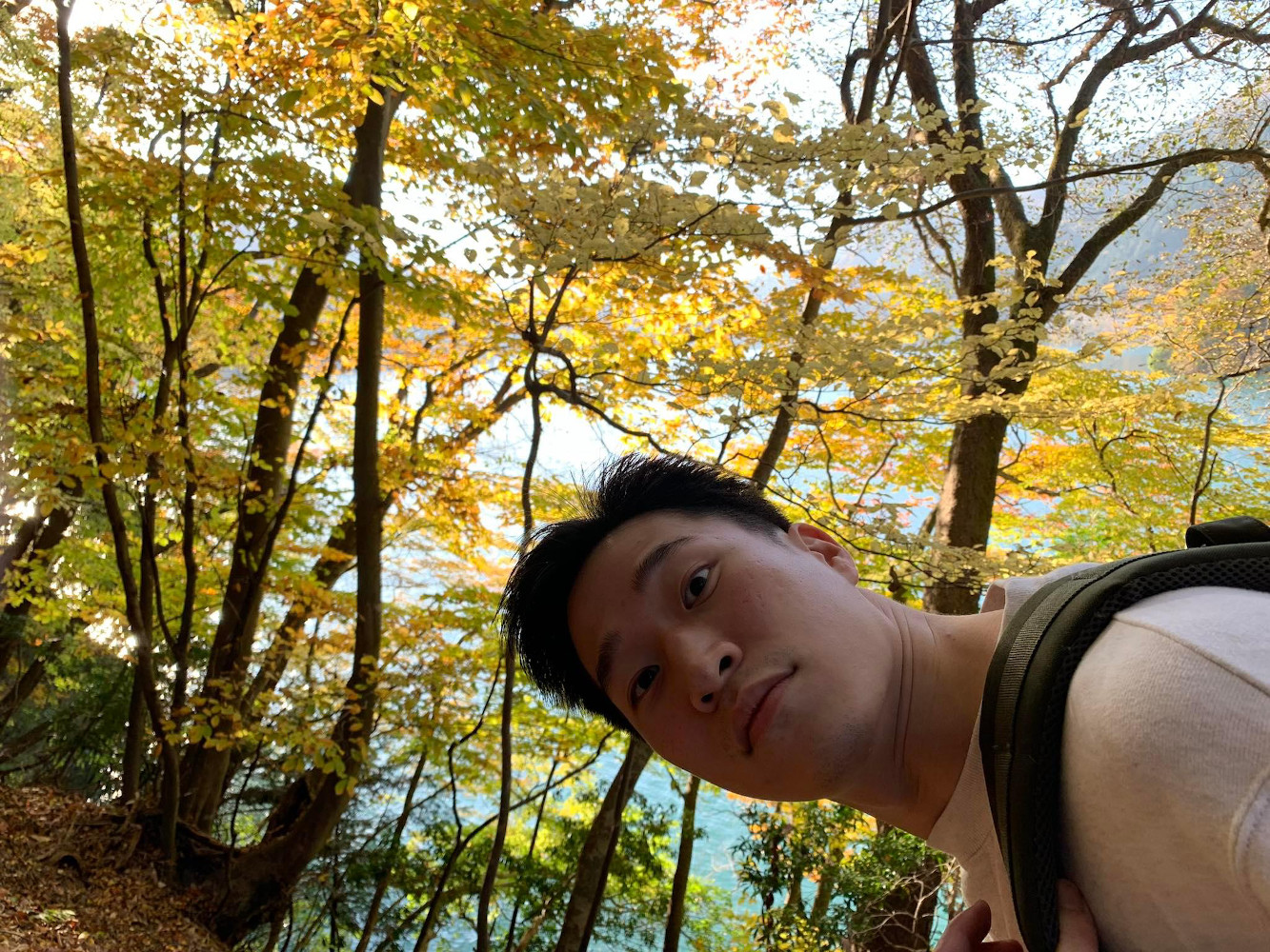 photograph of Ricky Choi on a hillside in the forest
